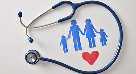 paper cut out family surrounded by a stethoscope
