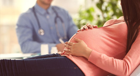 a pregnant lady visiting a doctor